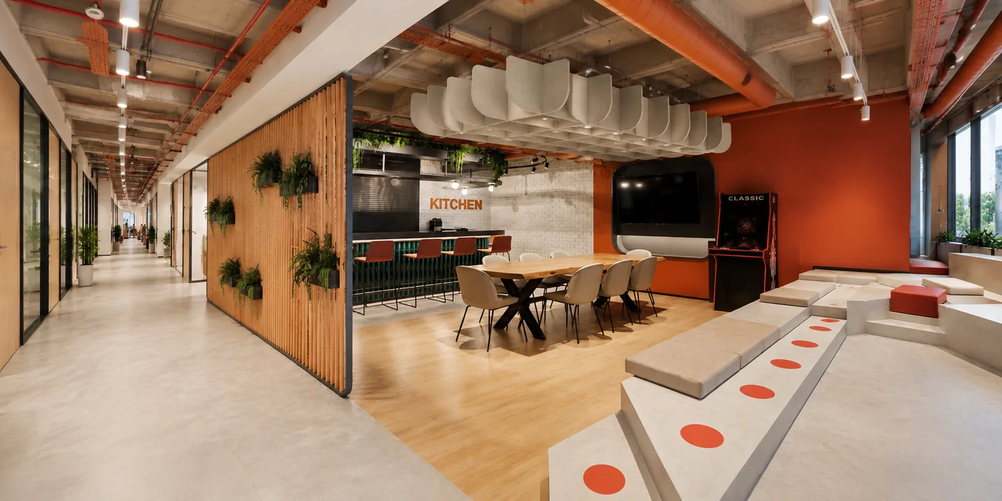 Office kitchen and social stair with acoustic baffles above a shared dining table